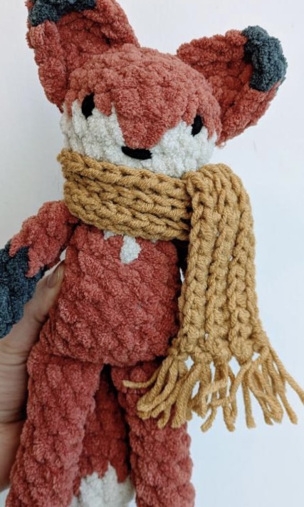 Crocheted fox with cozy yellow fable scarf.