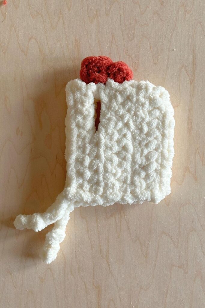 Photos showing how to add the comb to the top of the chicken hat for the completed outfit.