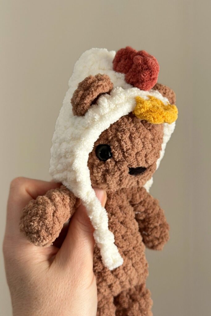 Photos showing how to add the beak to the chicken hat.