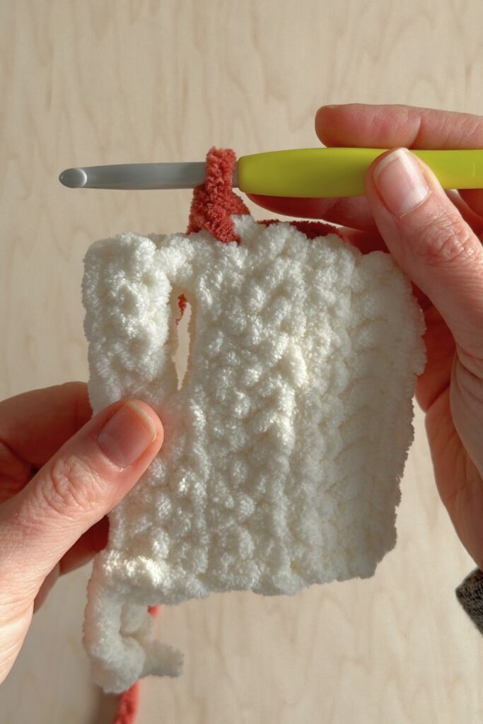 Showing how to begin the comb for on top of the chicken hat.