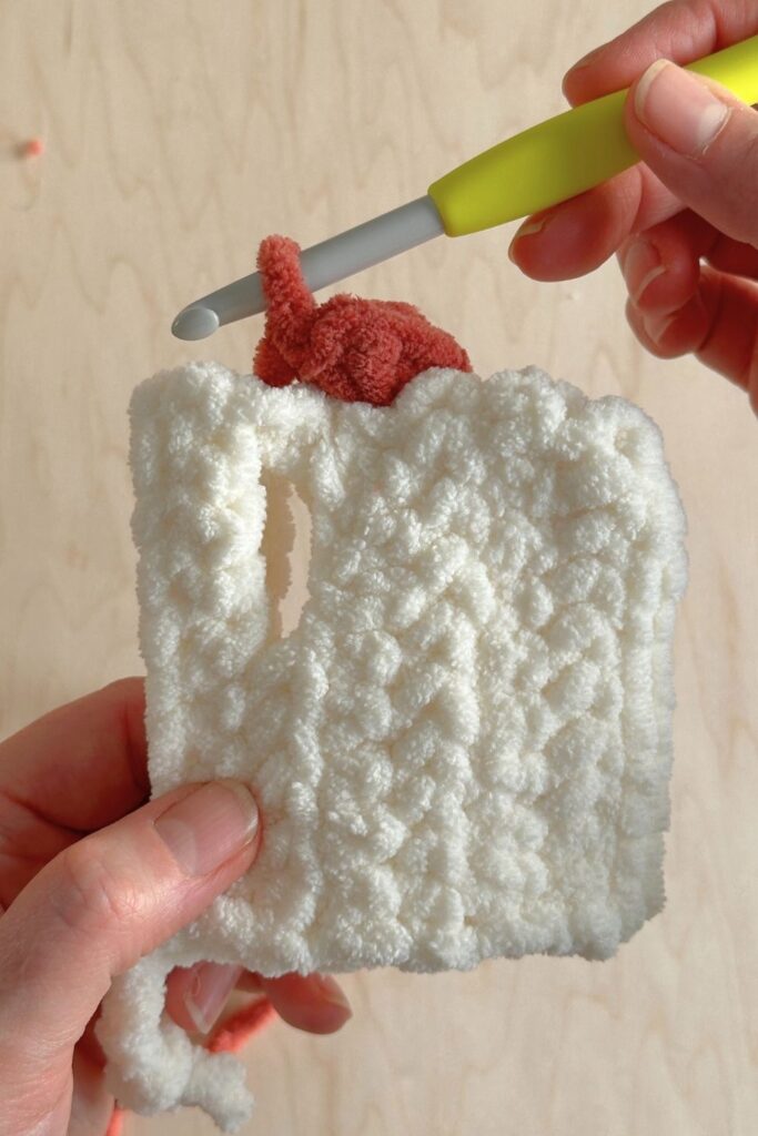 Close-up showing the proper stitch to make the comb for on top of the chicken hat.