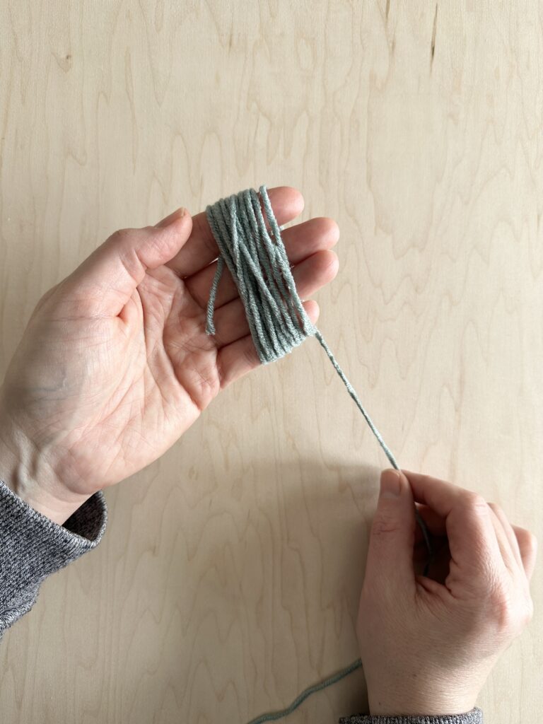 Thread wrapped around someone's fingers.