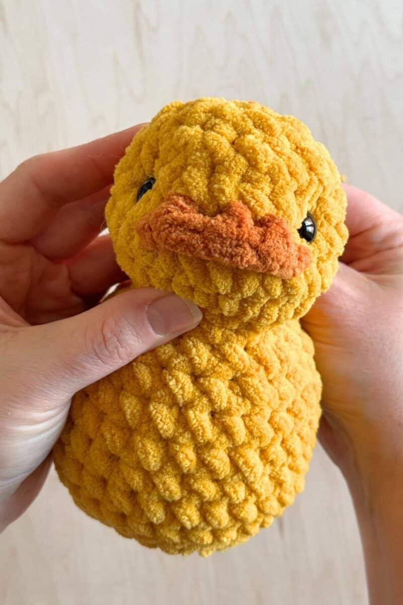 A crochet duck facing the camera.