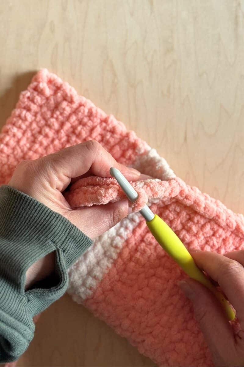 Process photo showing crocheting the flap of the sleeping bag. 