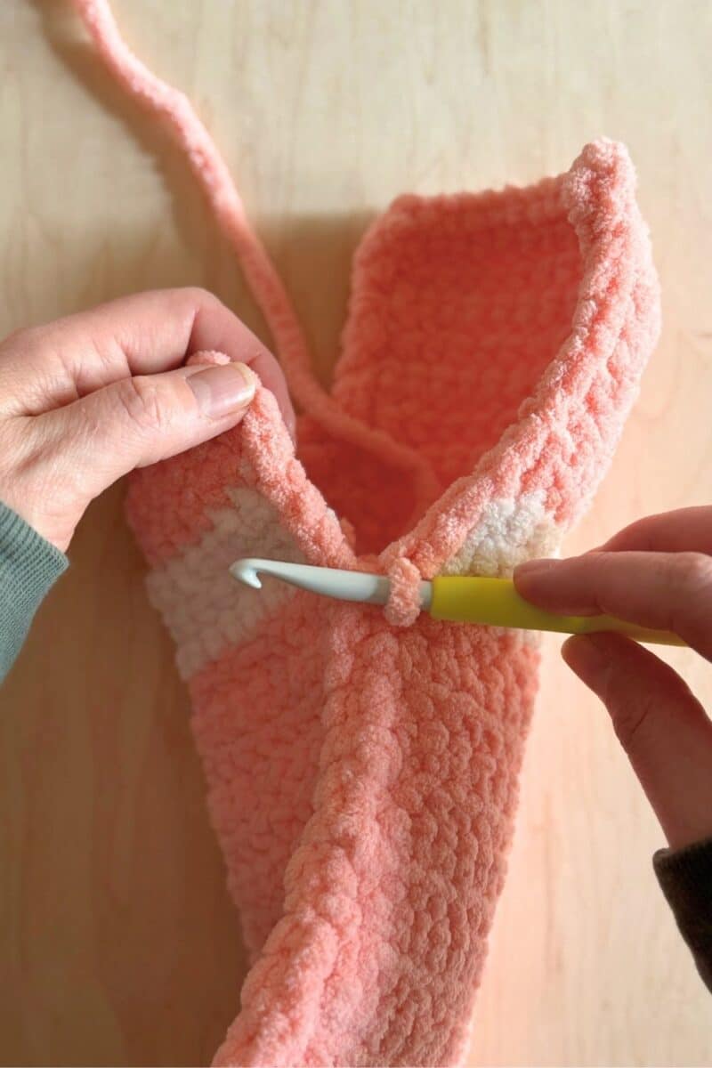 Process photo showing finishing the last stitches of the sleeping bag. 
