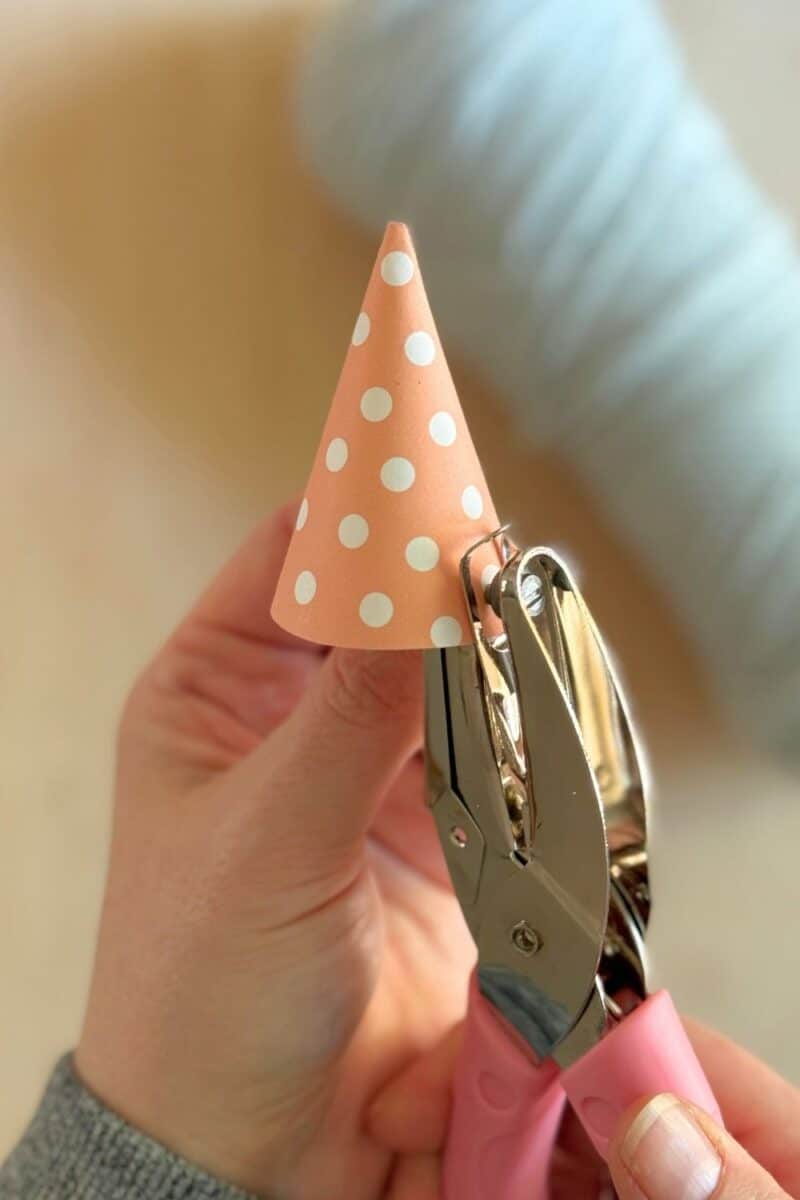 Image showing how to paper punch the birthday party hat.