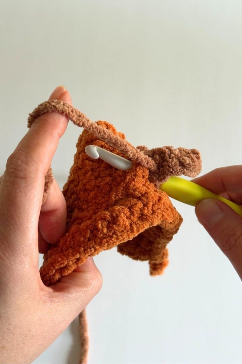 This photo shows slip stitching back into the hat to secure the stem.