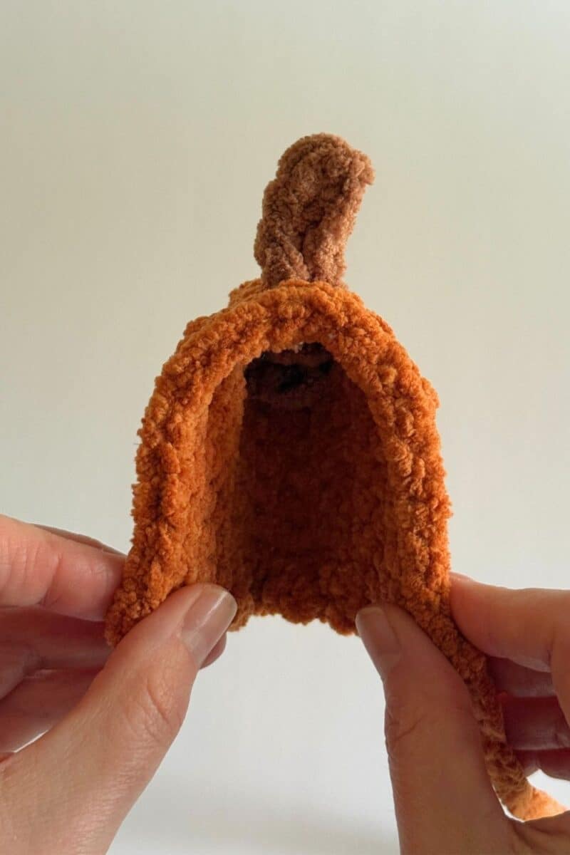 A photo of the finished crochet pumpkin hat.