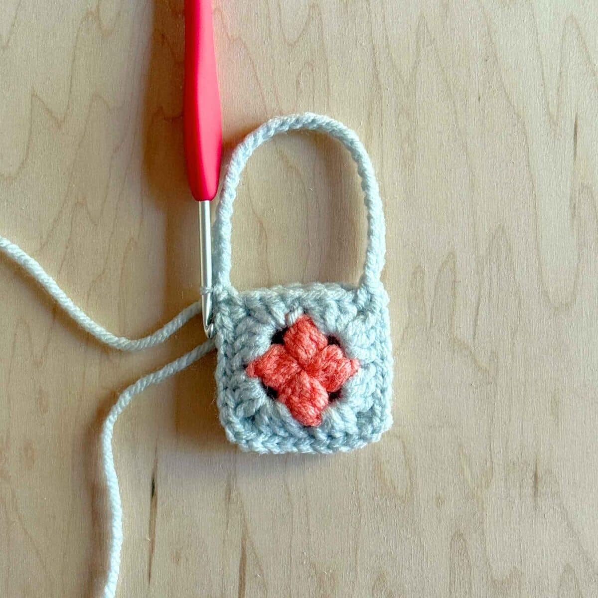 Showing the strap completed and attached to the other side of the purse.