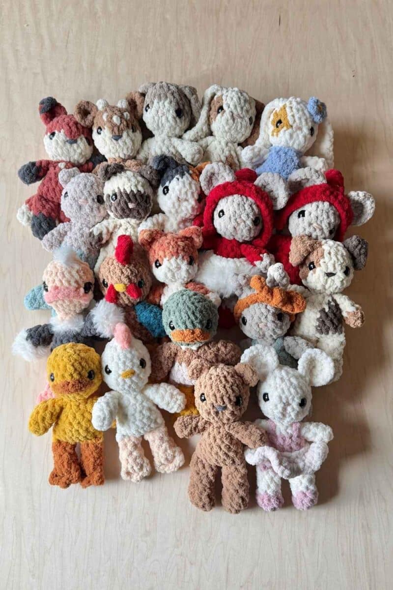 A large groups of crochet baby animals with various accessories.