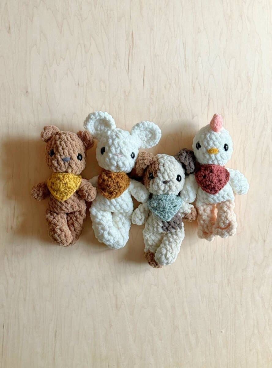 Photo of four Fable Babies wearing the neckerchief pattern.