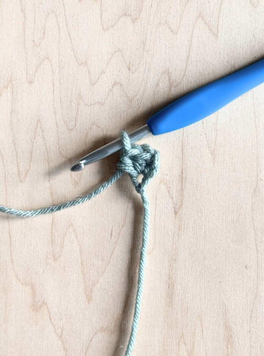 Process photo 1: first row of the neckerchief shown in blue yarn.