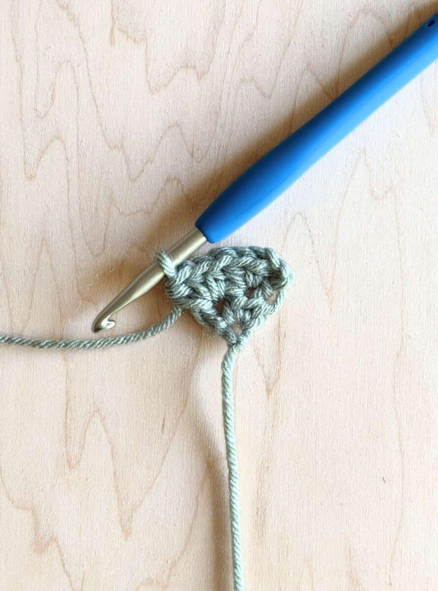 Process photo 2: second row of the neckerchief shown in blue yarn.