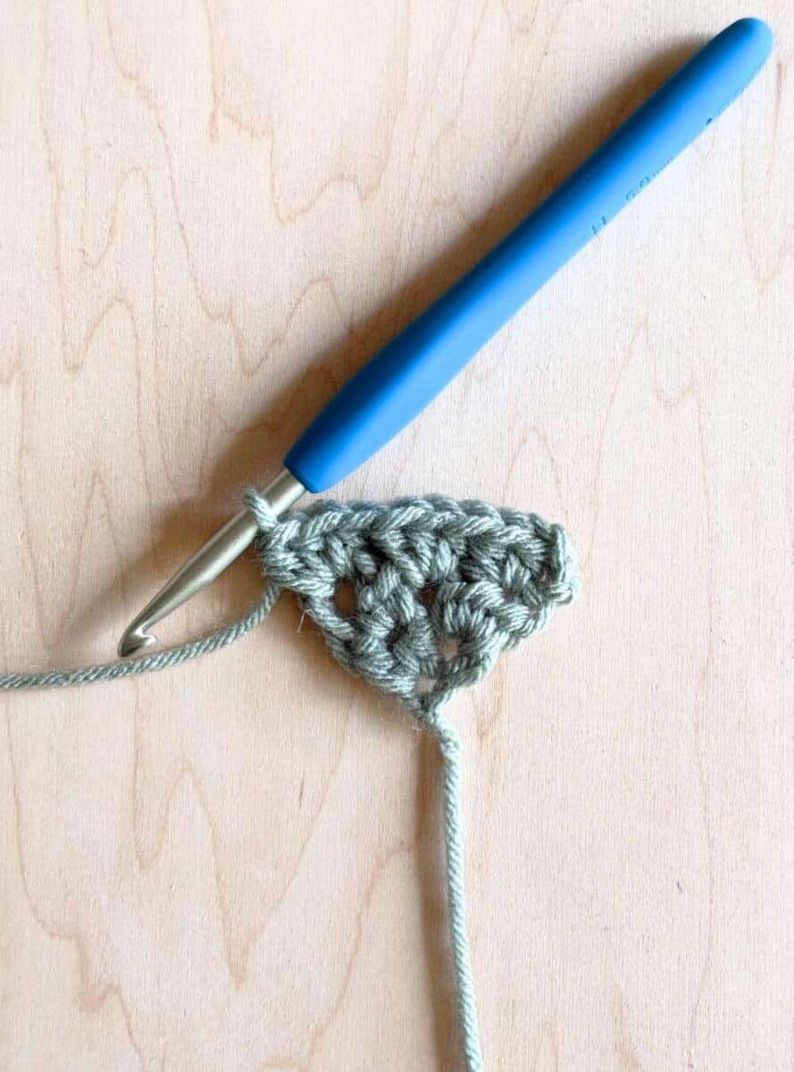 Process photo 3: third row of the neckerchief shown in blue yarn.