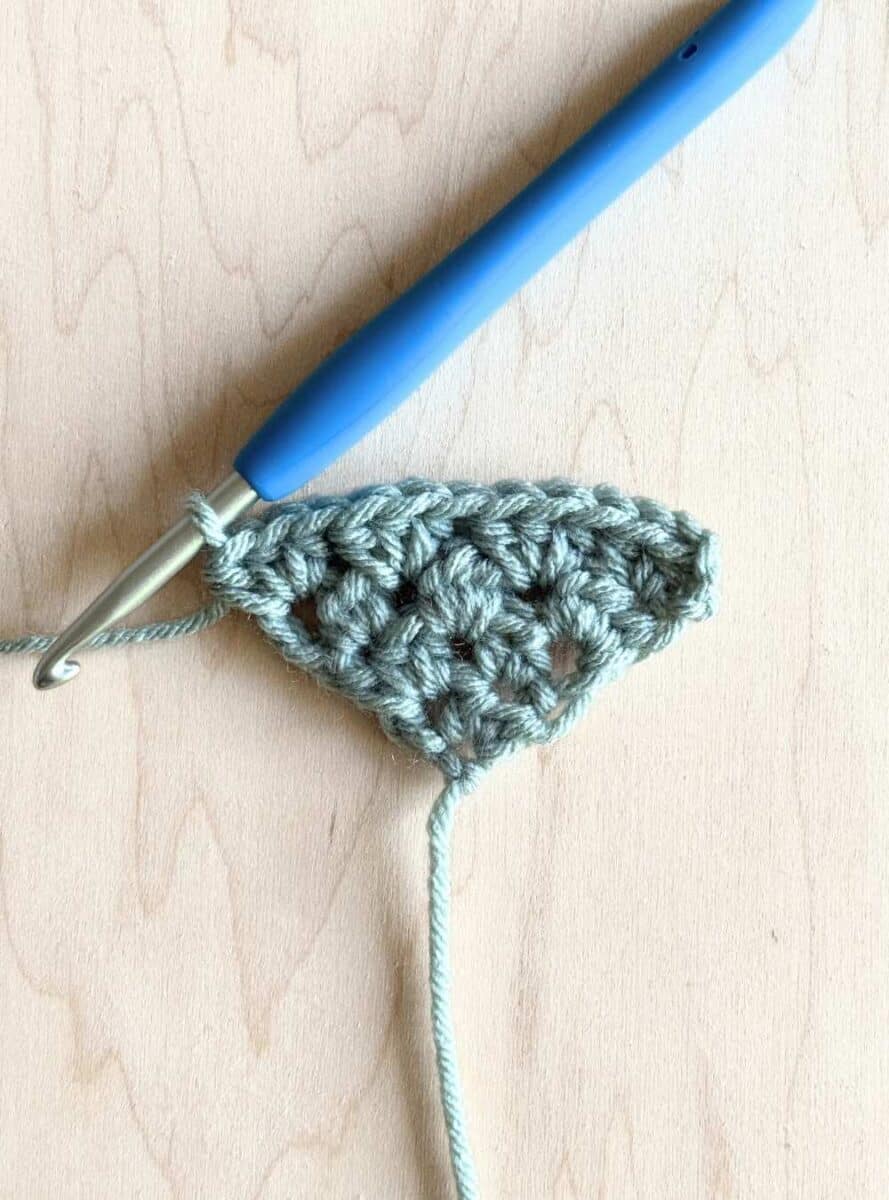 Process photo 4: fourth row of the neckerchief shown in blue yarn.