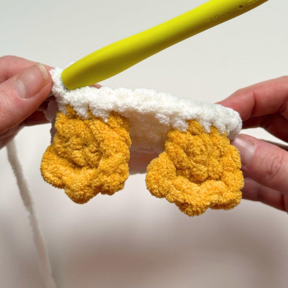 Process photo showing the feet crocheted into the body of the crochet goose.