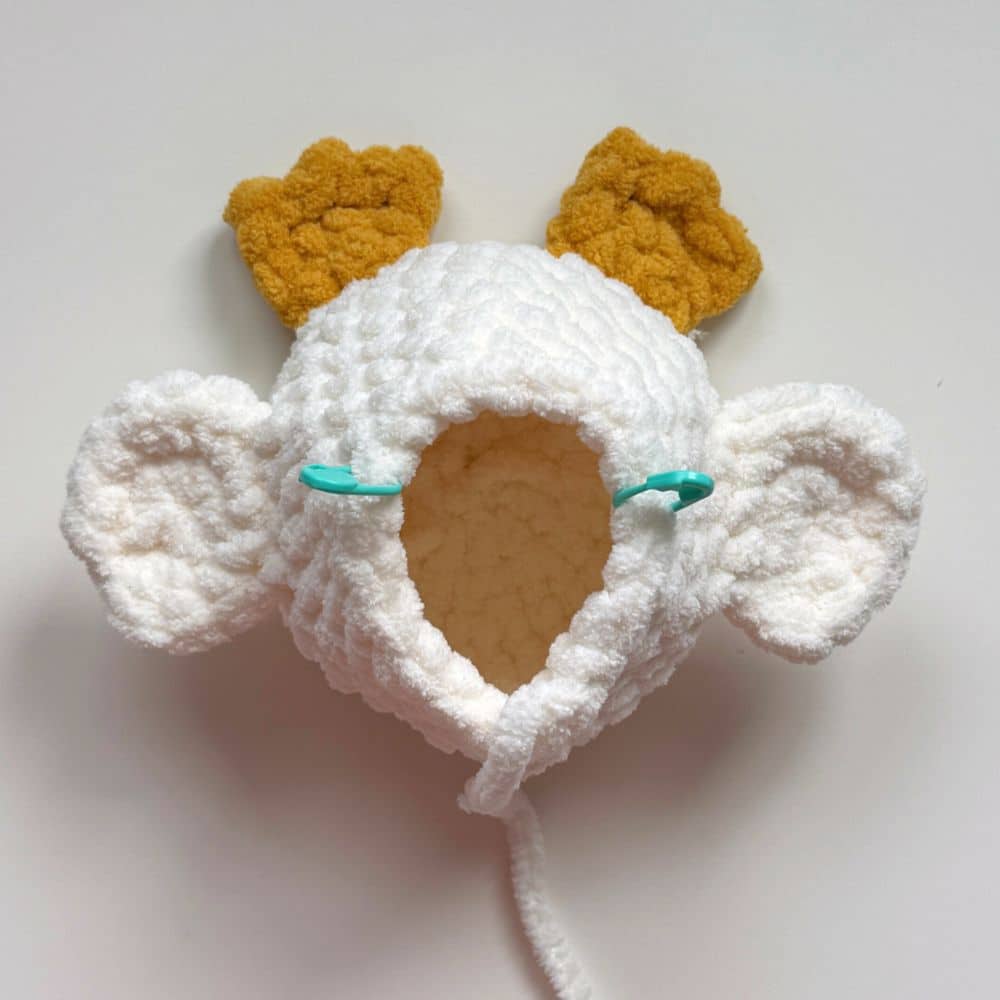 Process photo showing stitch markers on the body where the head will be added.