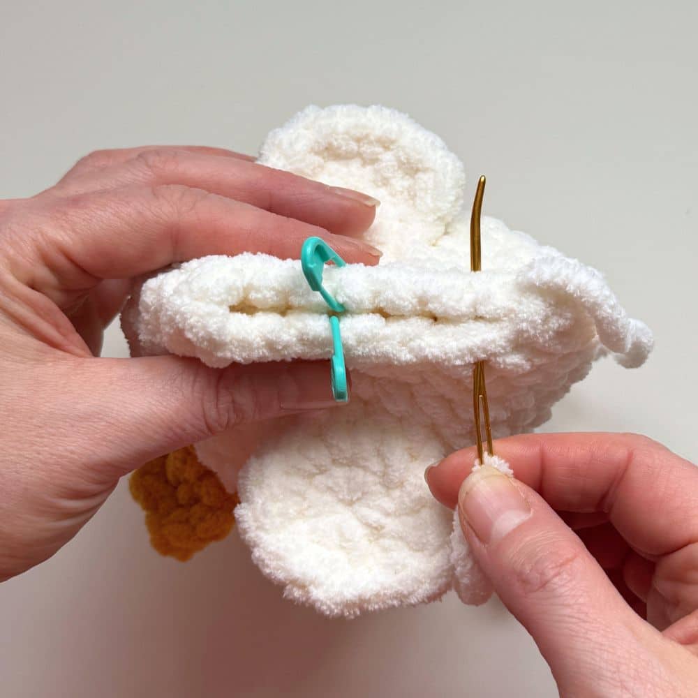 Process photo showing steps to slip stitch the back of the goose closed.