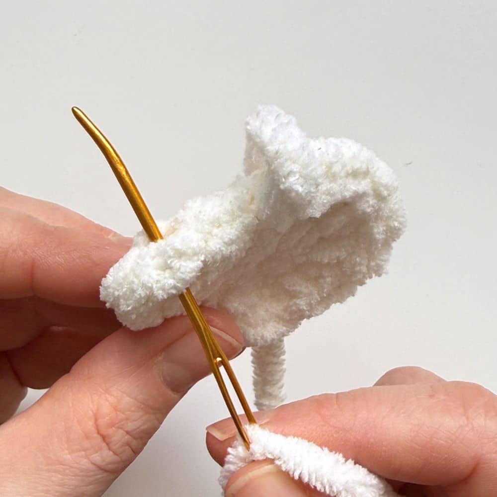 Process photo showing how to finish off the crochet goose wing.