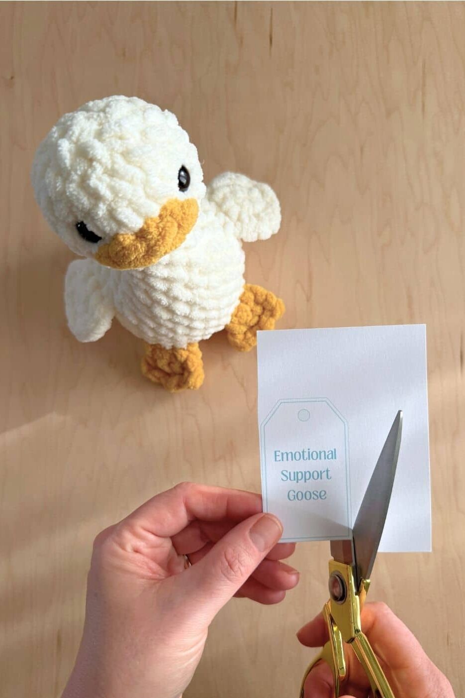 Hands cutting a gift tag with scissors.