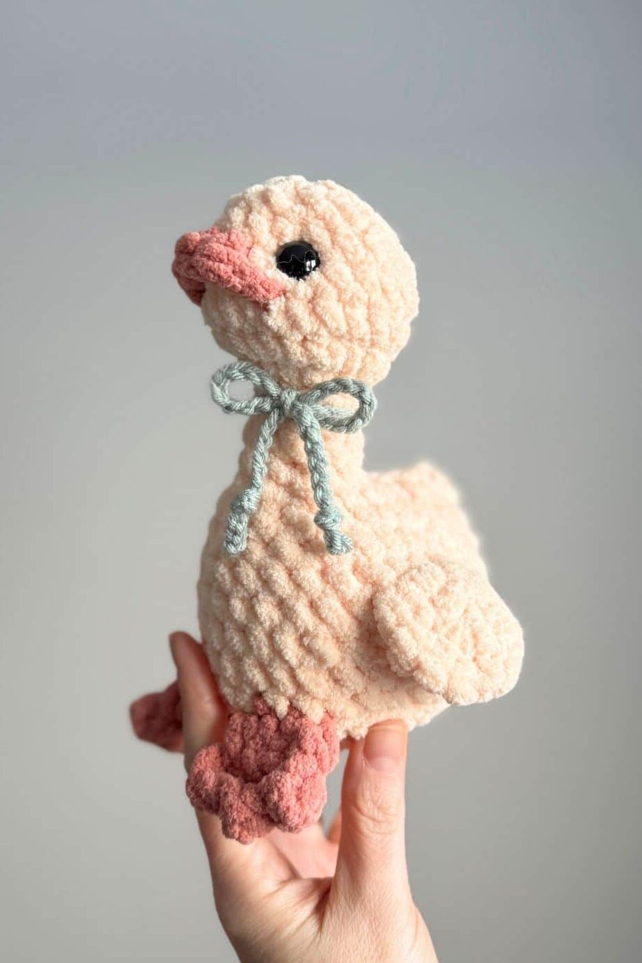 Photo of a cream coloured crochet goose.