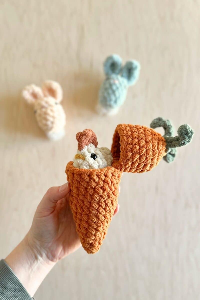 A hatching carrot with a crochet chicken inside.