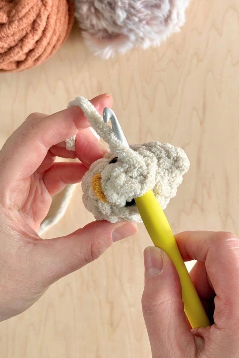 Working a crochet stitch into the top of the head.