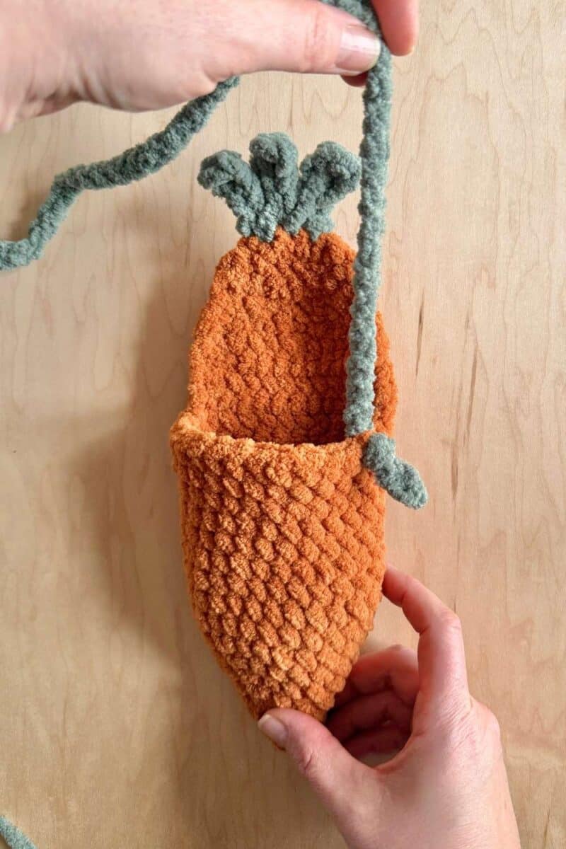 Pulling the chain through to attach the first side of the strap.