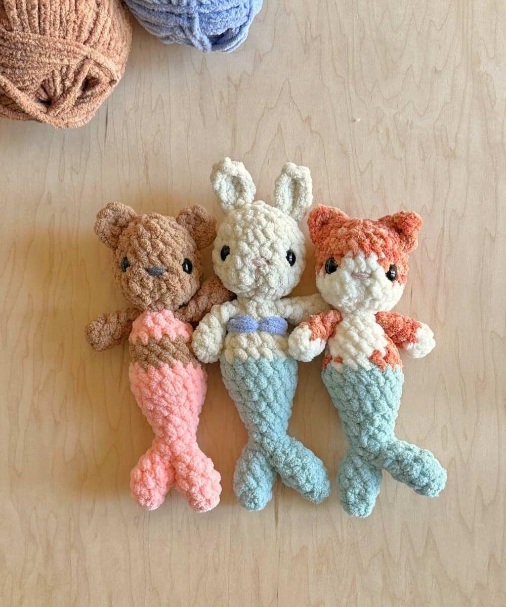 Three baby crochet mermaid babies in bright colors.