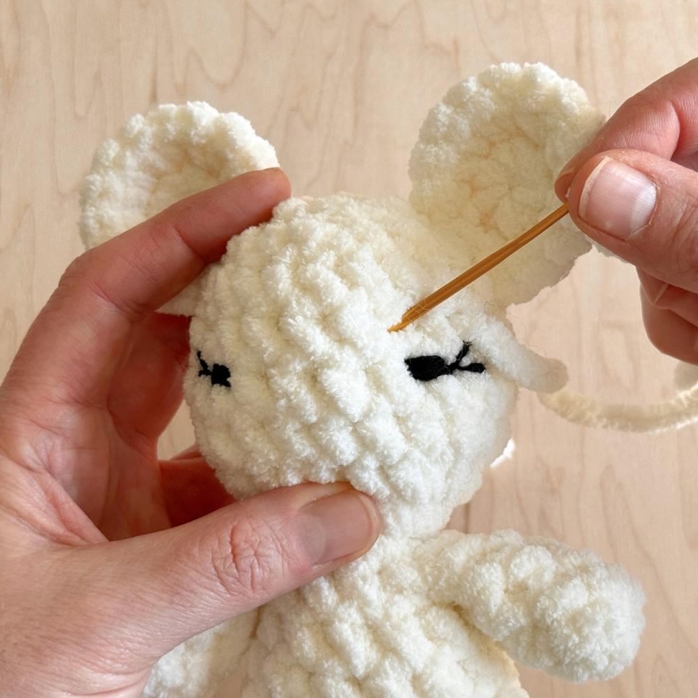 First steps of shaping the eye on a crochet mouse.