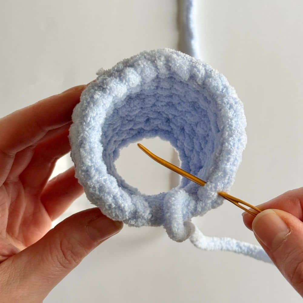 Process photo showing how to complete an invisible finish step on a crochet piece. (Step two)