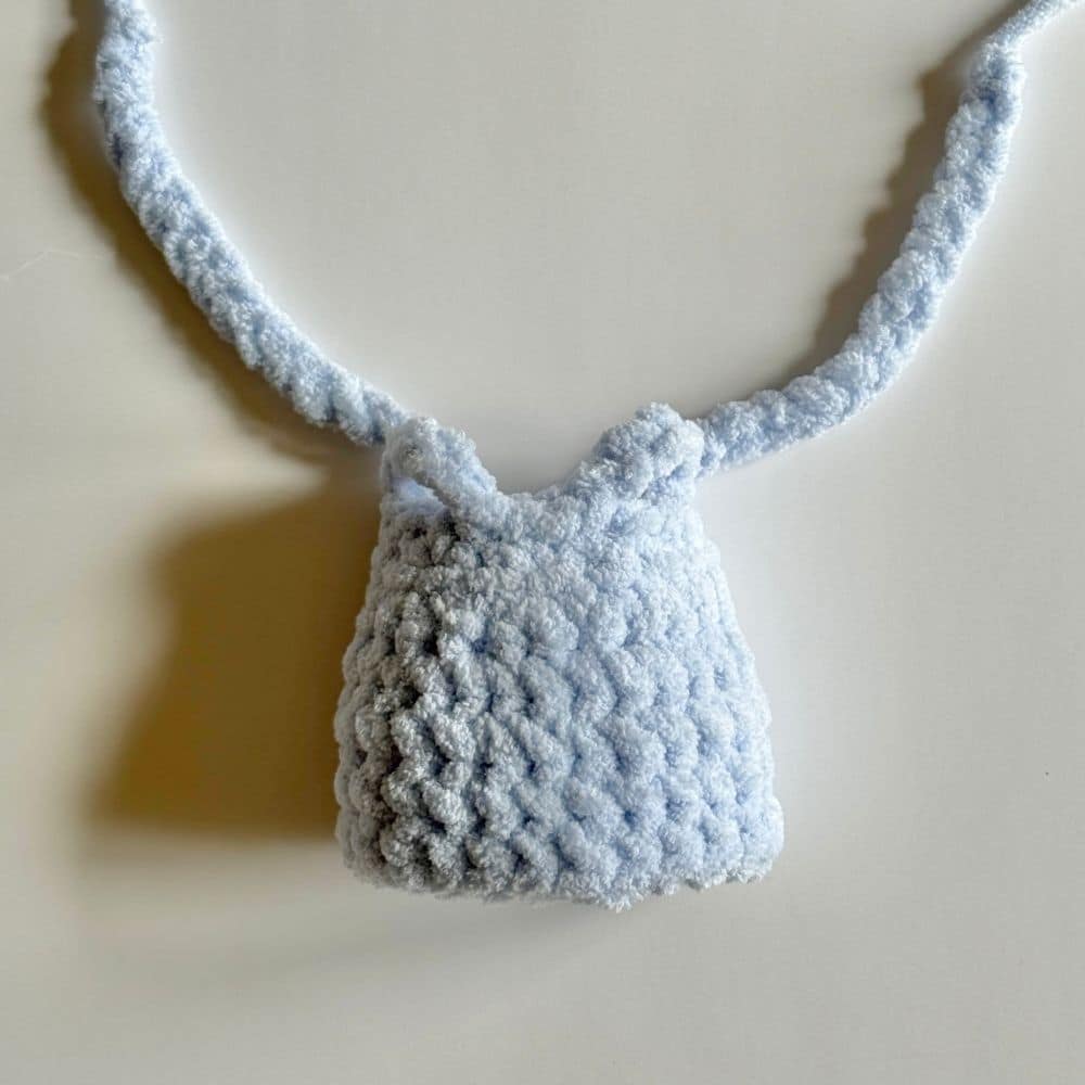 Arm holes and ties completed on the blue crochet dress.