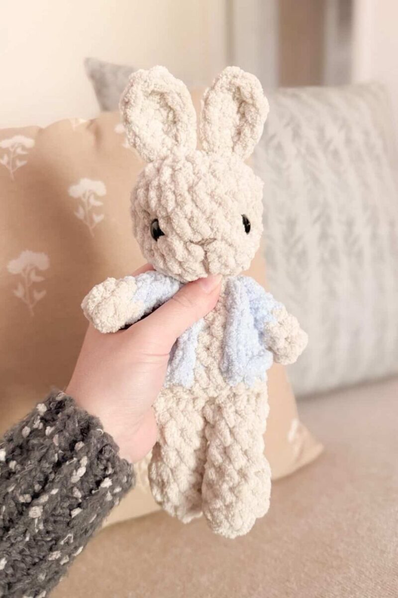 Hand holding a crochet Peter Rabbit Garden Bunny.