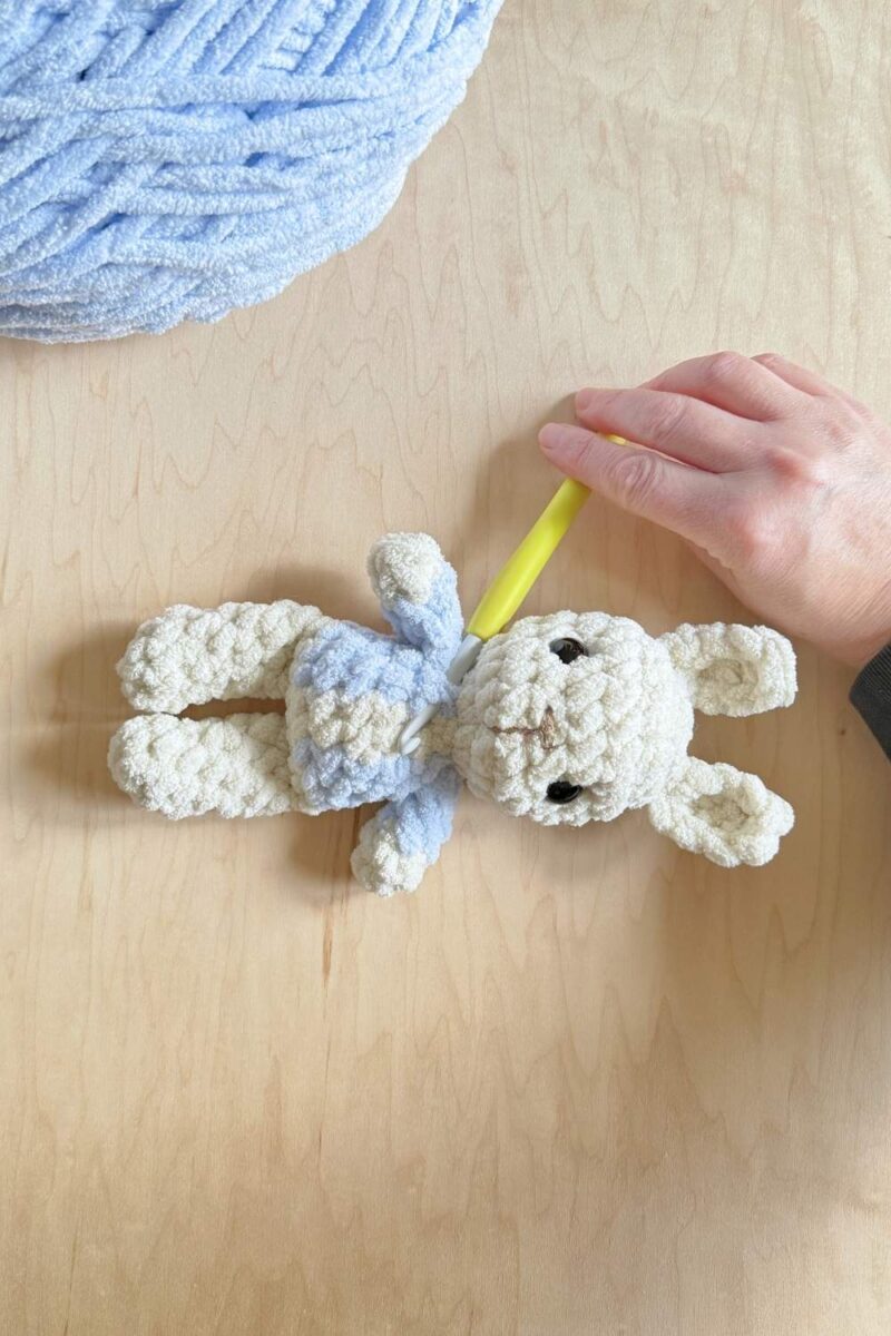 Process photo of adding top stitching to a jacket on a Peter Rabbit bunny.