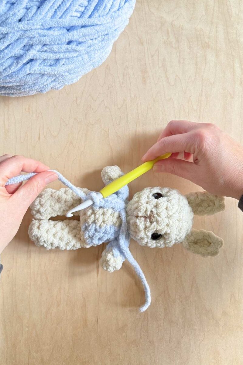 Process photo adding top stitching to a jacket on a Peter Rabbit bunny.