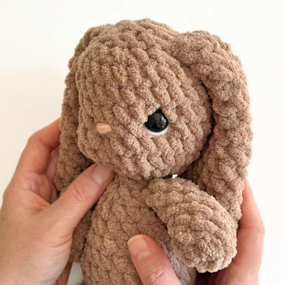 Finished photo showing the white added to the underside of the safetly eye on the crochet bunny.