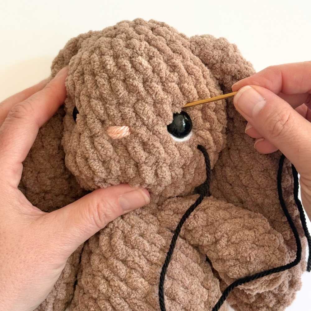 Process photo number 1 showing black yarn being added to the eye.