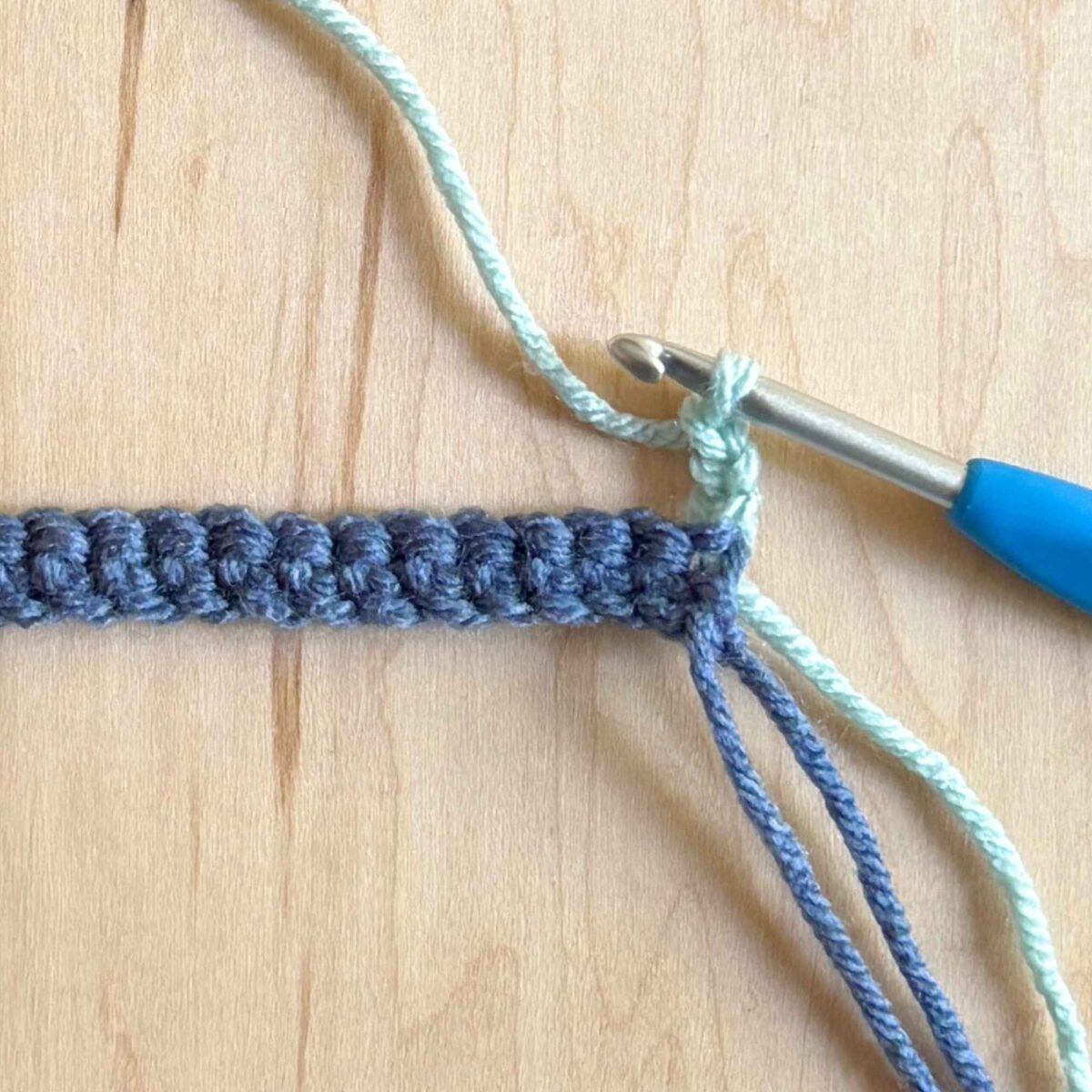 Process photo showing how to start row 2 of the hat.