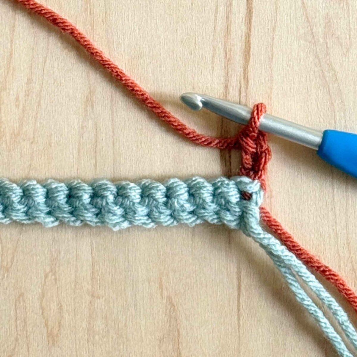 A photo showing how to begin row 2 of the hat.