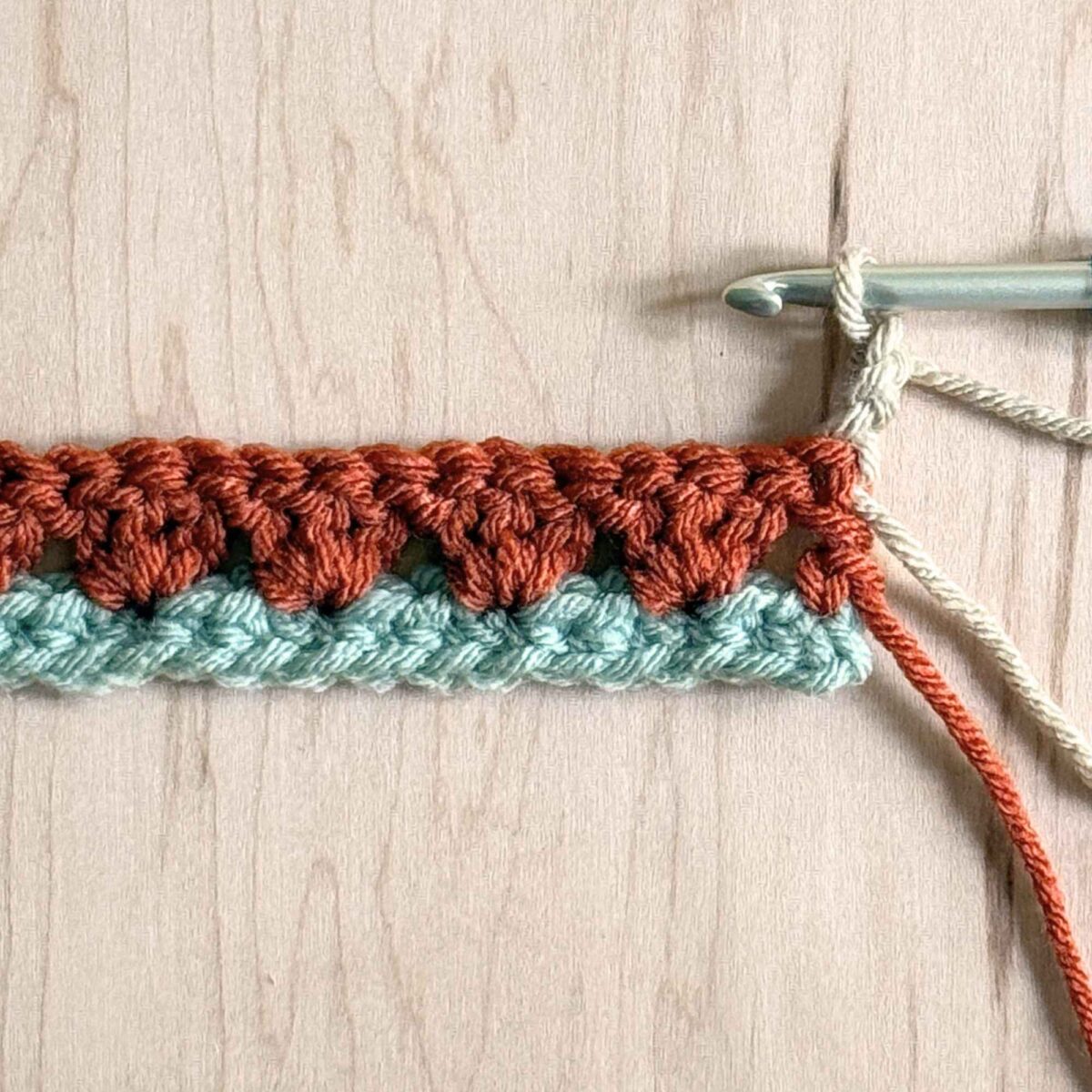 A photo showing how to start row 3 of the crochet hat pattern.