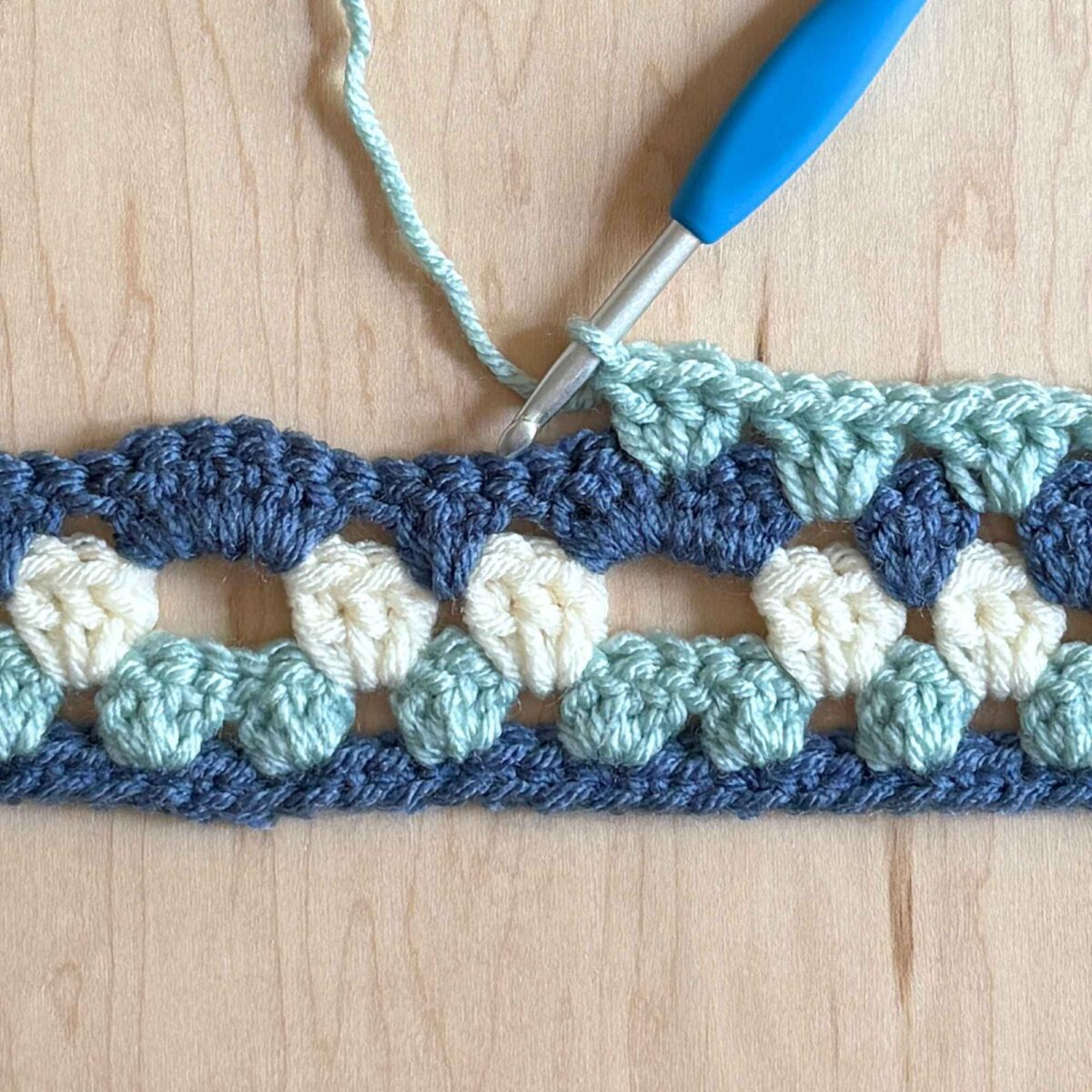 A process photo showing a step from row 5 of the crochet hat.