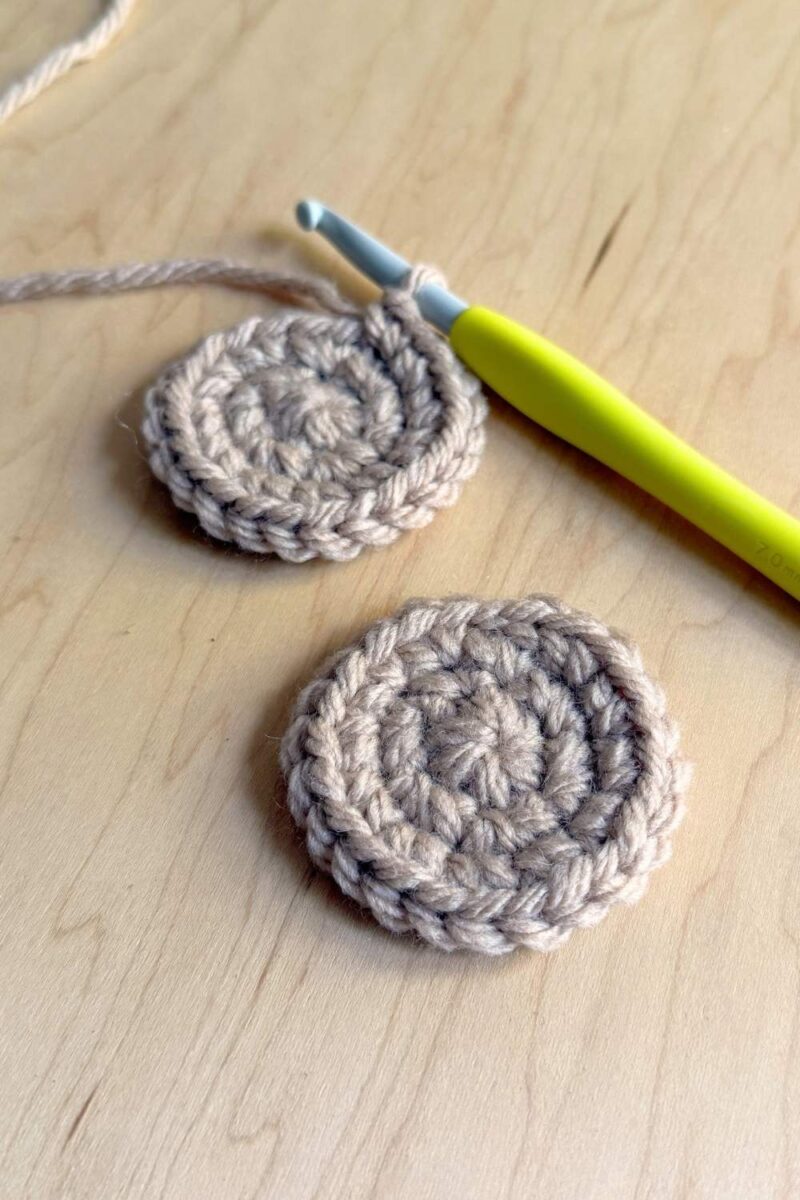 A process photo of two crochet cookies without chocolate chips.