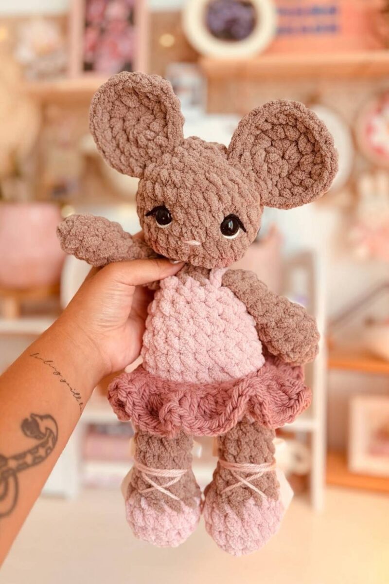 A brown crochet mouse wearing a punk ballet outfit and tutu.
