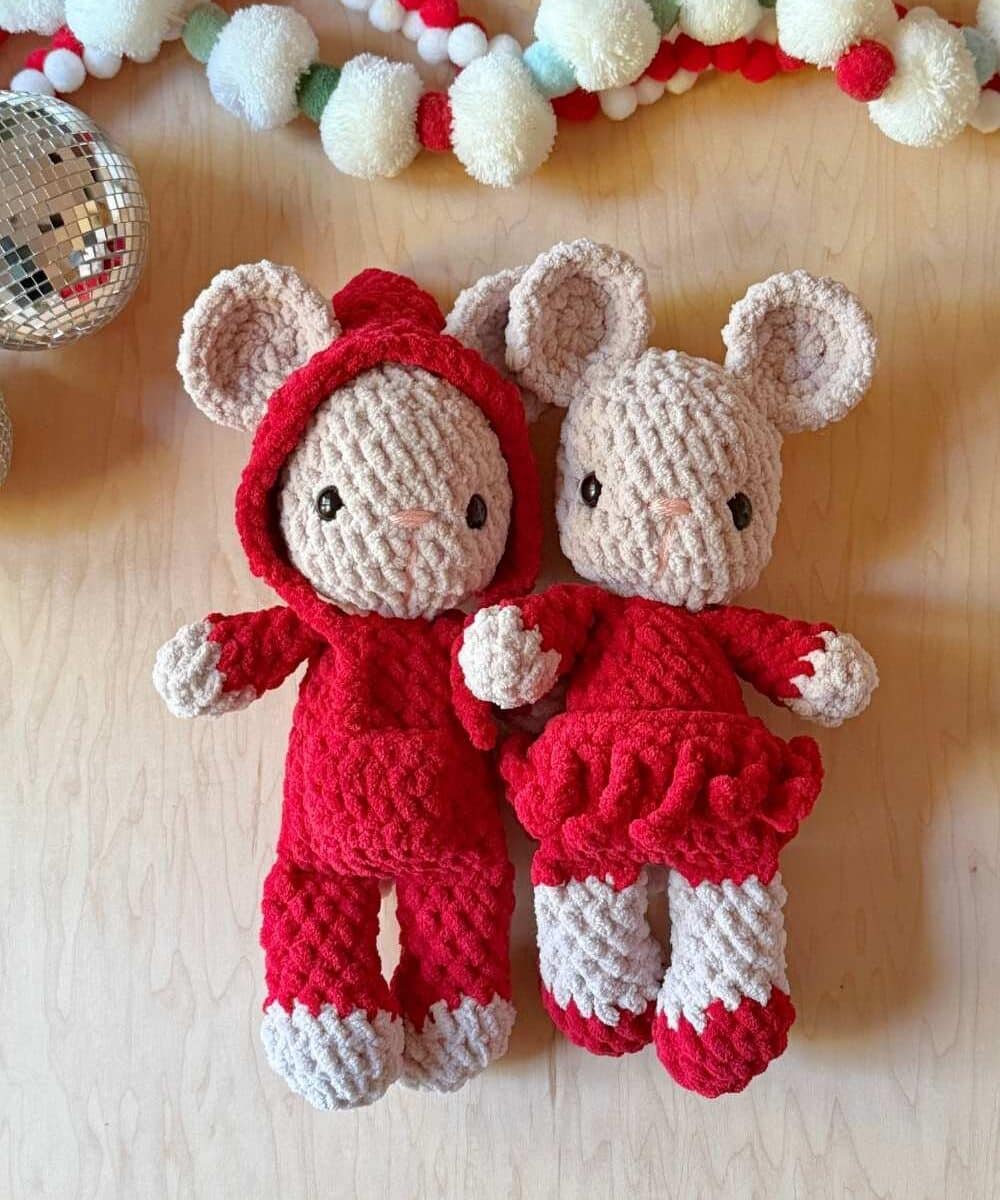 Two crochet Christmas mice with Christmas decor around them.