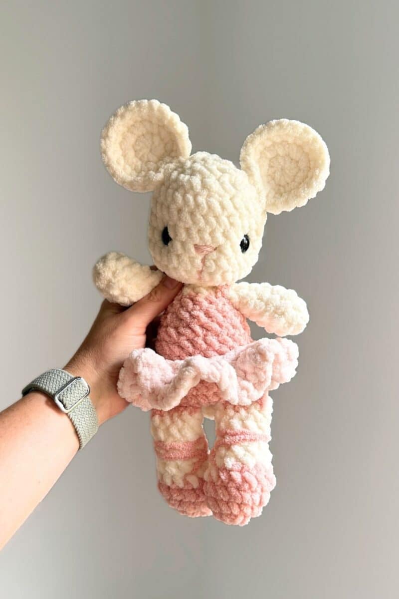 A pink and white crochet ballet mouse.