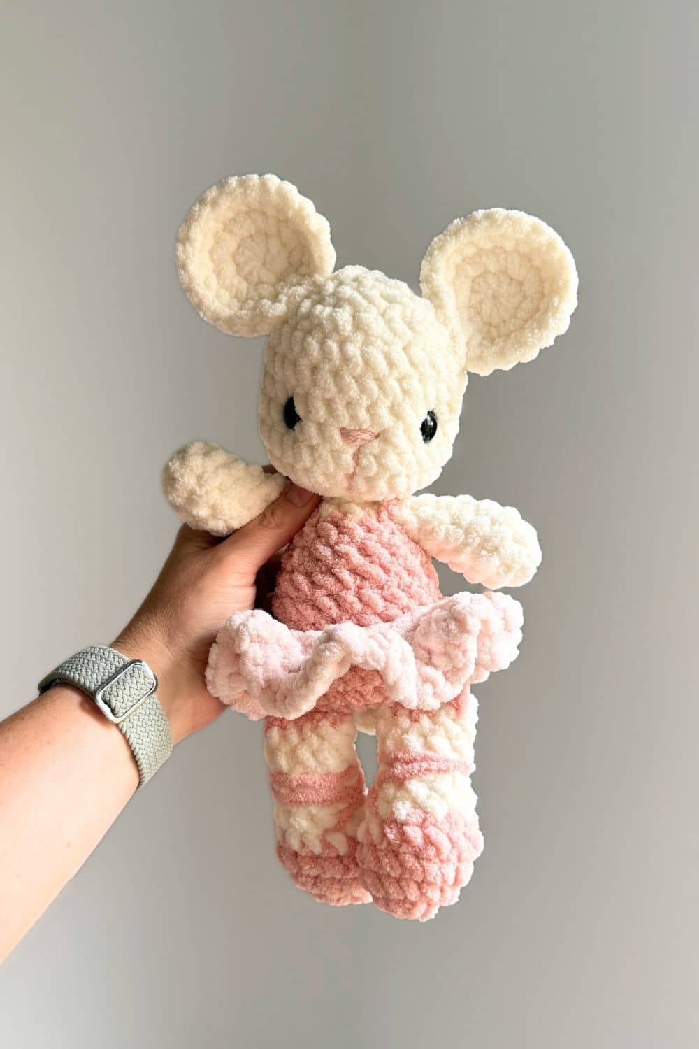 A pink and white crochet ballet mouse.