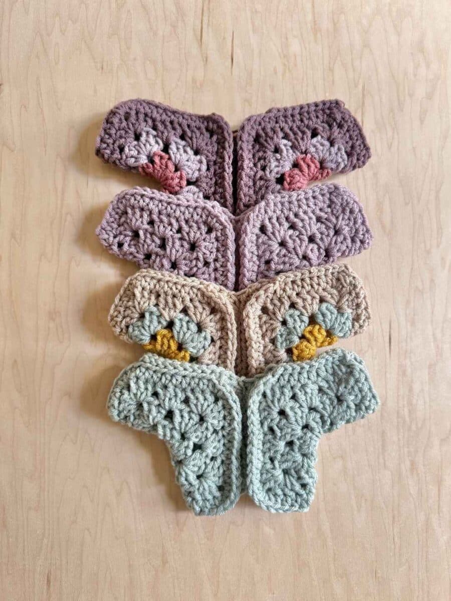 4 different doll cardigans laying together.