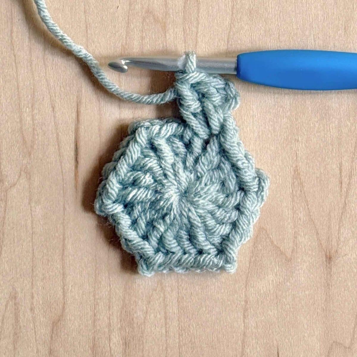 Process photo showing round 2 of the crochet hexagon.