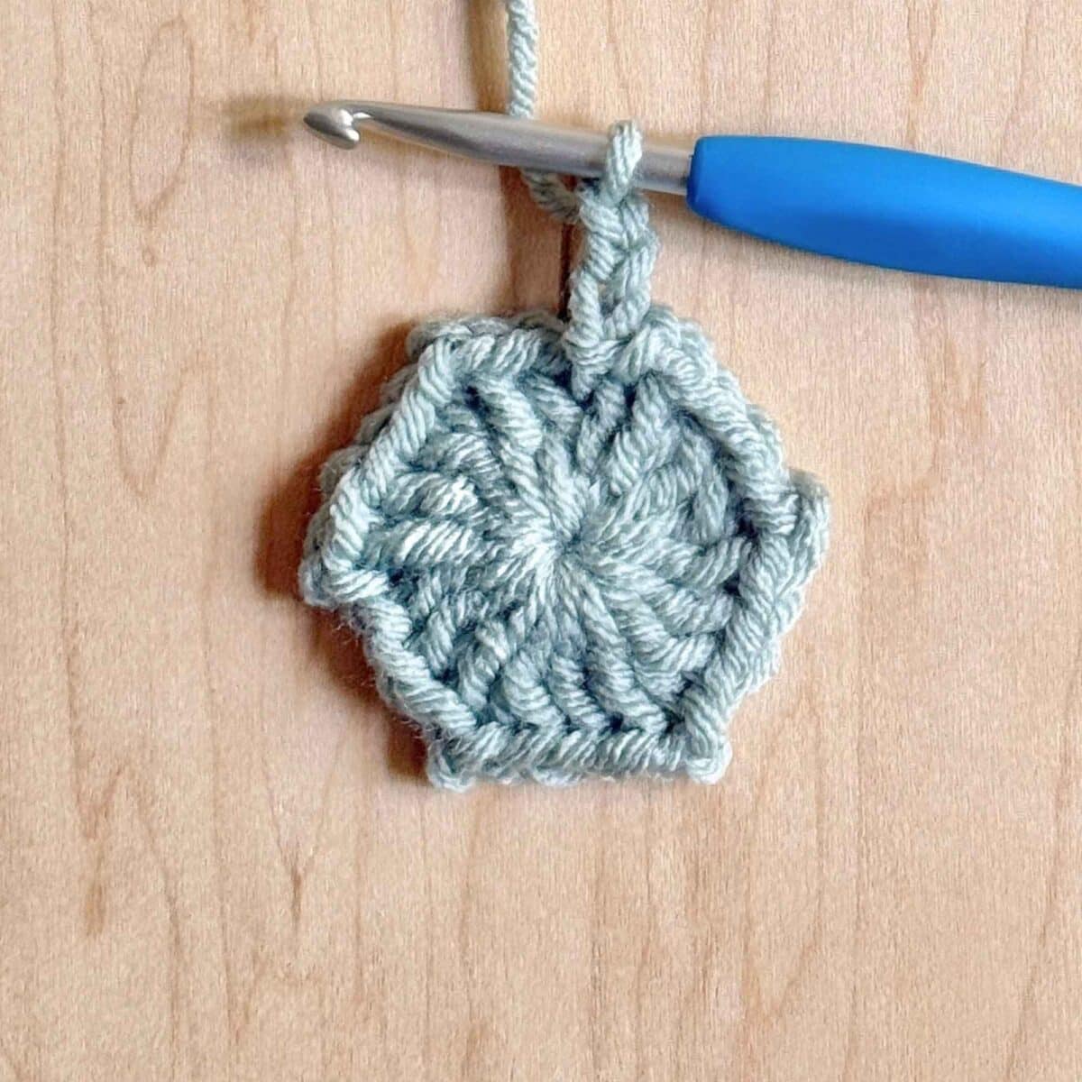 Process photo showing round 1 of the crochet hexagon.