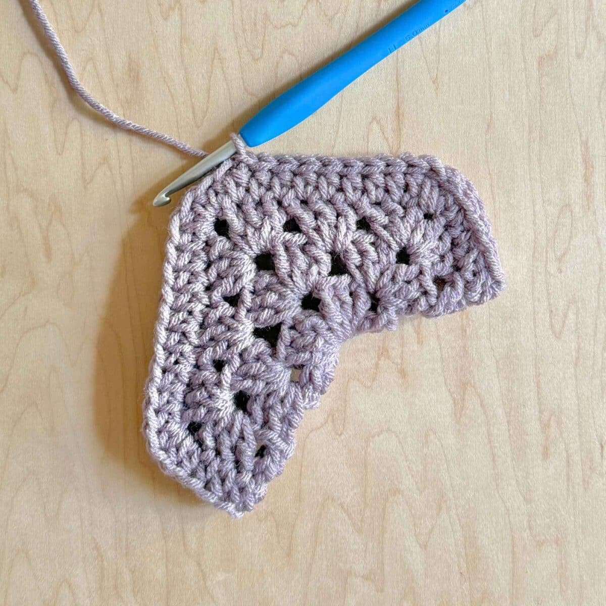 Process photo showing finished stitches on the hexagon.